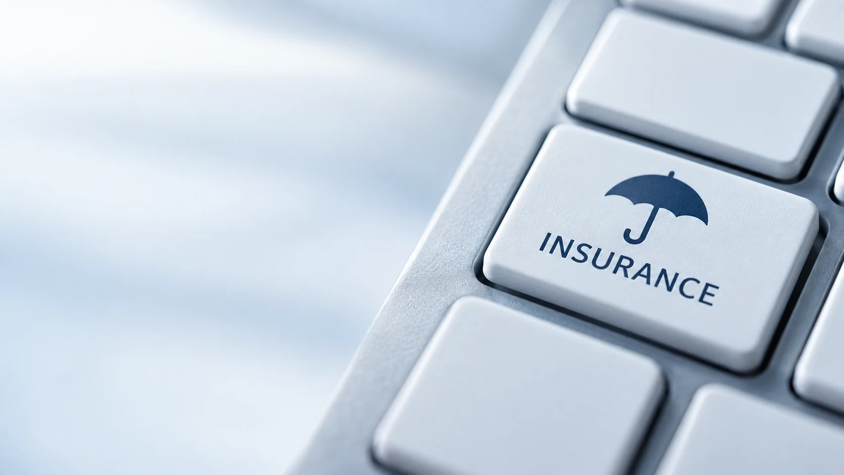 Tecla de computador com símbolo de guarda-chuva e a palavra Insurance